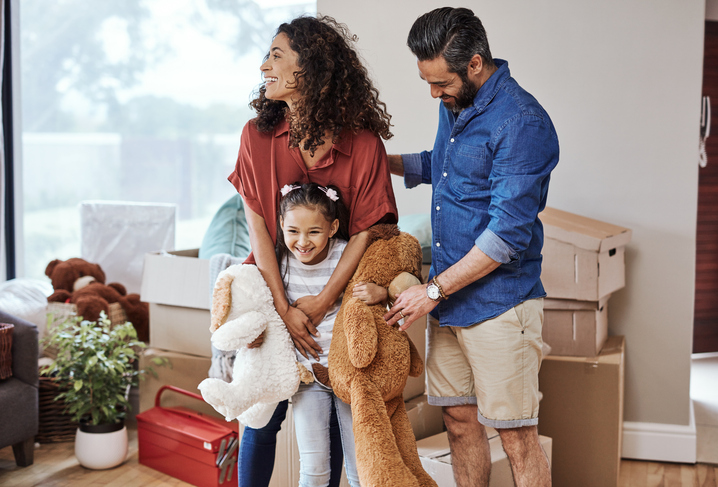 Family Sharing a Joyful Moment While Moving Into Their New Home